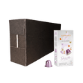 Carraro Decerato aluminum coffee capsules shown with a large dark brown cardboard shipping box, a white branded product box, and one individual metallic purple capsule on a plain white background.