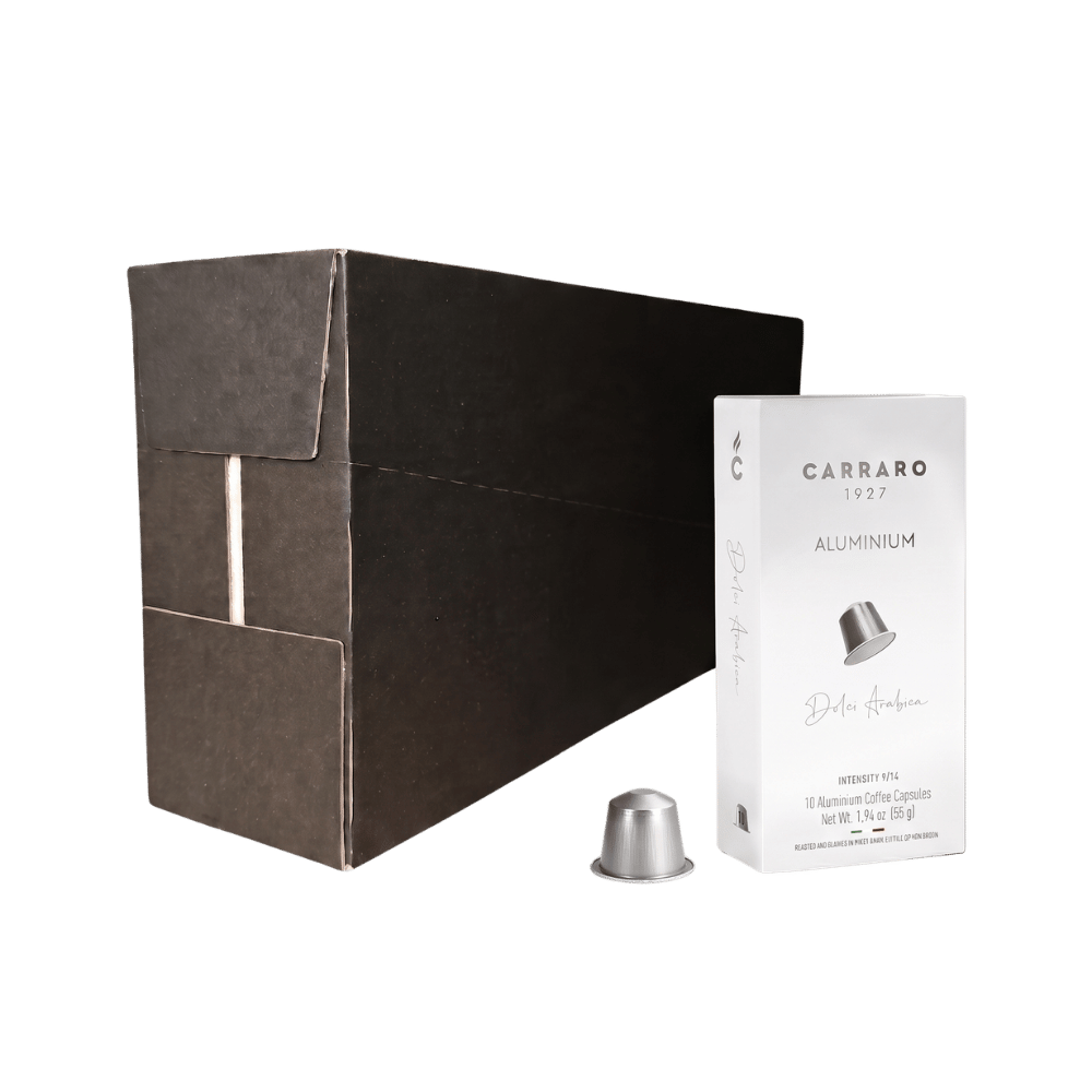 Carraro 1923 coffee capsule packaging showing a large matte black outer box, a white inner package labeled 'Aluminium', and a single silver capsule on a plain white background.