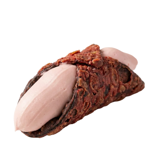 Chocolate pastry with pink cream filling on a white surface